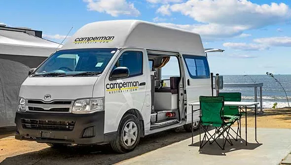 Camperman Australia branded hi-top campervan parked at a roadside stop