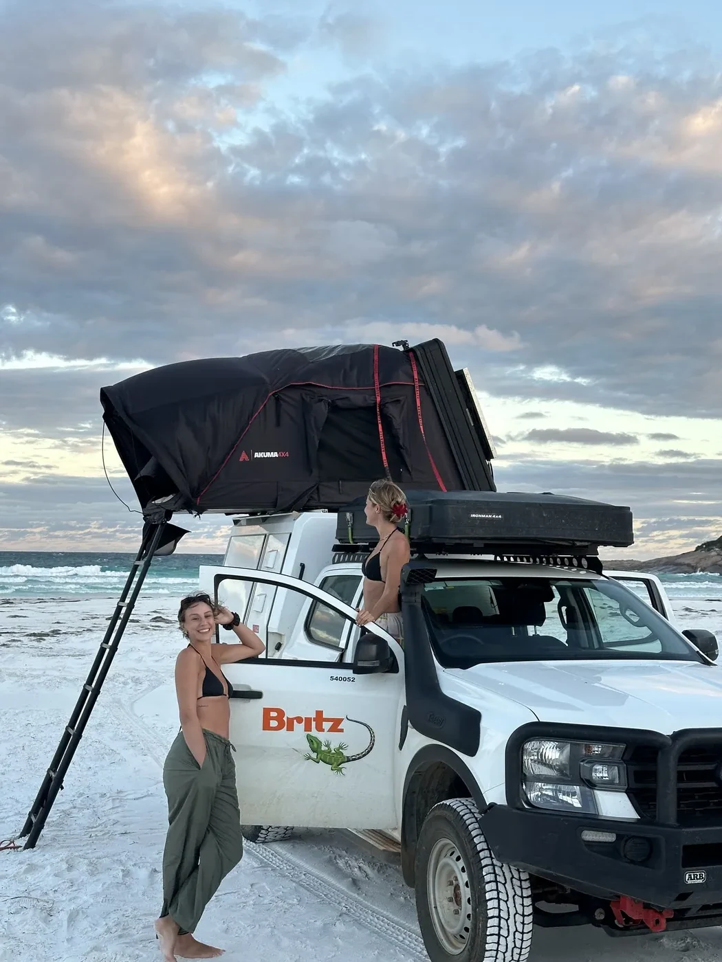 Britz 4WD Warrior with rooftop tent deployed on a white sand beach at sunset in Esperance, Western Australia