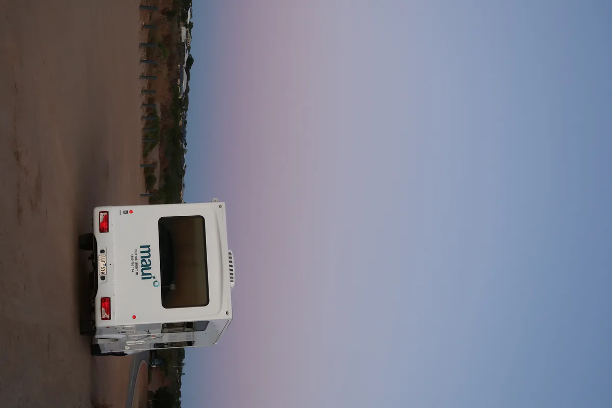 Campervan on an Australian road at sunset