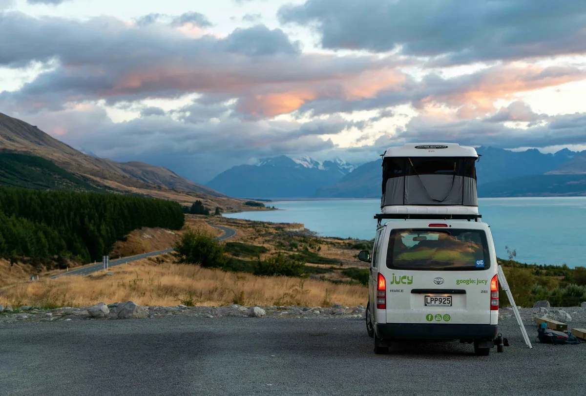 Multiple campervans parked at a beach campsite