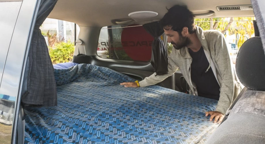 Interior of a Spaceships Beta campervan showing bed setup