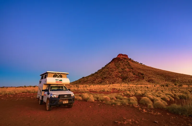 Campervan parked in the Australian outback at golden hour